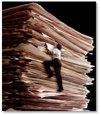 man climbing mountain of paper work