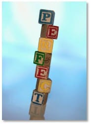 tower of building blocks spelling out "perfect"